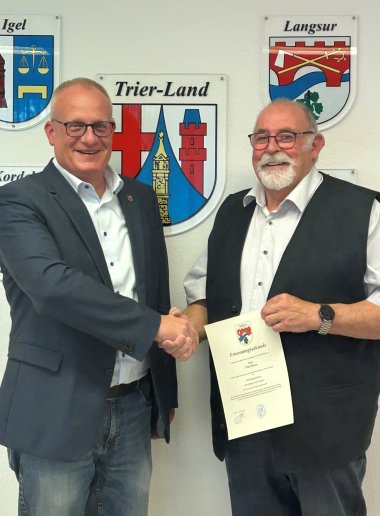 Bürgermeister Michael Holstein gratuliert Peter Bruns (r.) zur Wahl zum Ortsbürgermeister der Ortsgemeinde Langsur.